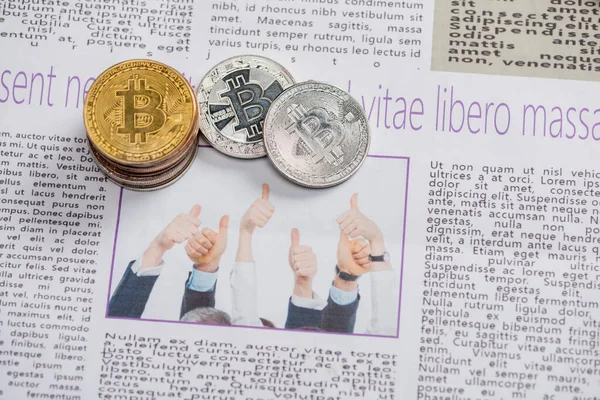 KYIV, UKRAINE - NOVEMBER 1, 2021:  top view of bitcoins on printed newspaper with lettering, translation: free life but risky — Stock Photo