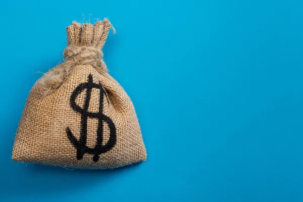 Top view of canvas money bag on blue — Stock Photo