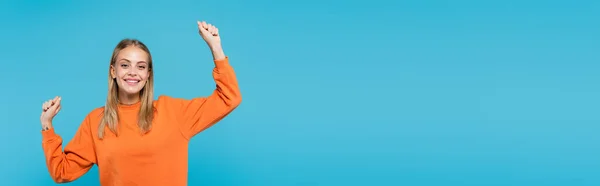 Excited blonde woman showing yes gesture isolated on blue, banner — Stock Photo