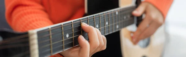 Cropped view of young woman playing acoustic guitar at home, banner — Stock Photo