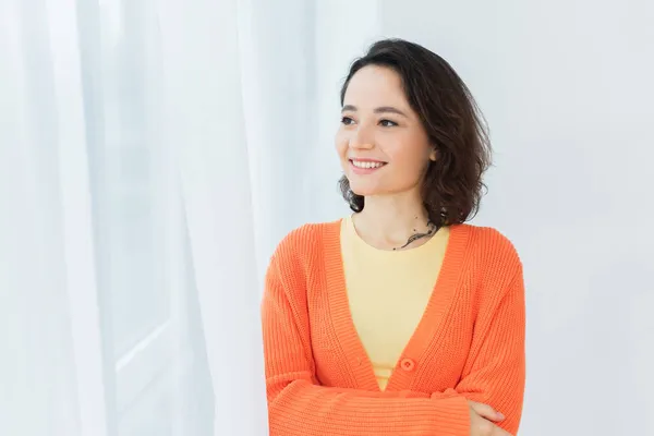 Tattooed and pleased young woman smiling at home — Stock Photo