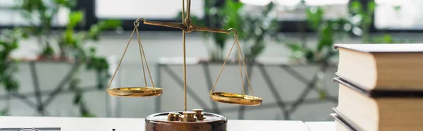 Blurred books and bronze justice scales on office desk, anti-corruption concept, banner — Stock Photo