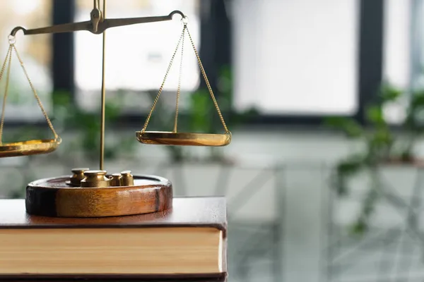 Close up view of bronze justice scales on codex book in office, anti-corruption concept — Stock Photo