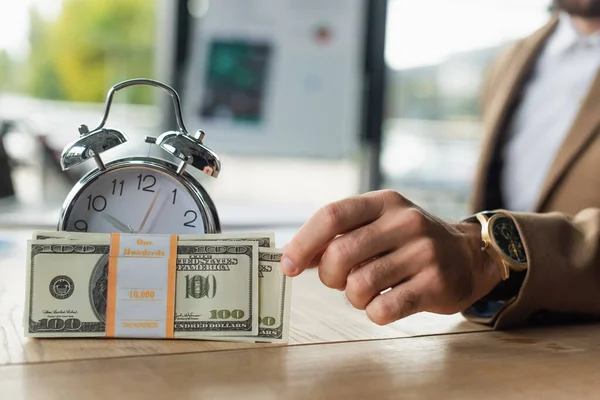 KYIV, UKRAINE - SEPTEMBER 22, 2021: partial view of businessman holding dollar banknotes near vintage alarm lock, anti-corruption concept — Stock Photo