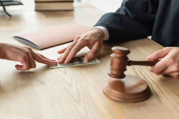 Partial view of judge taking bribe from client while holding gavel, anti-corruption concept — Stock Photo