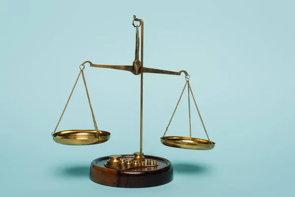 Bronze justice scales on blue background, anti-corruption concept — Stock Photo