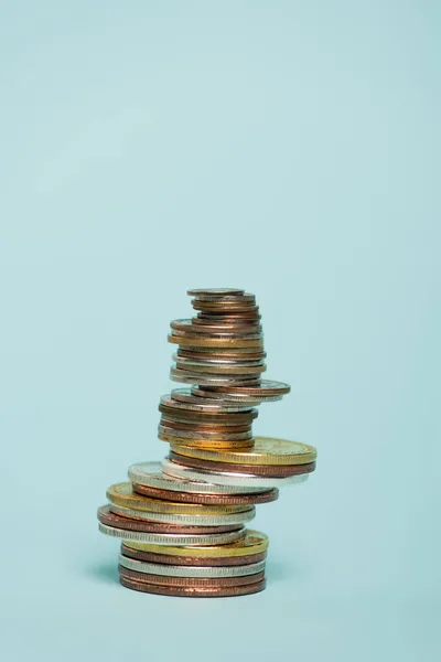 Stack of golden and silver coins on blue background with copy space, anti-corruption concept — Stock Photo