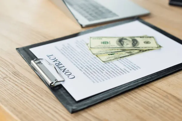 Dollar banknotes on contract near blurred laptop, anti-corruption concept — Stock Photo