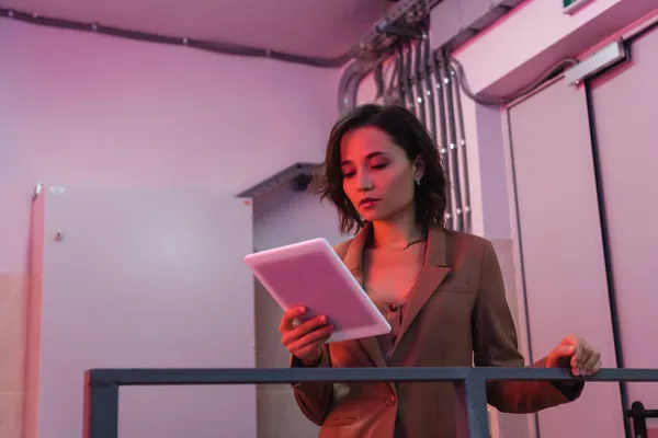 Young programmer in data center looking at digital tablet — Stock Photo