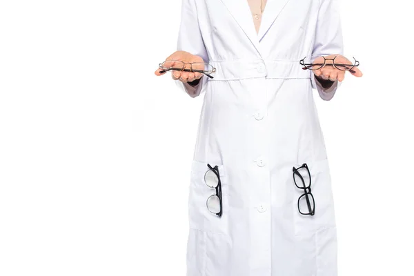 Cropped view of african american oculist in white coat holding eyeglasses on hands isolated on white — Stock Photo