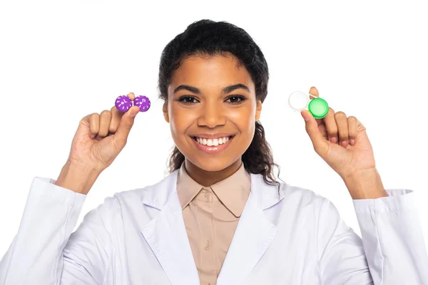 African american doctor holding containers with contact lenses isolated on white — Stock Photo
