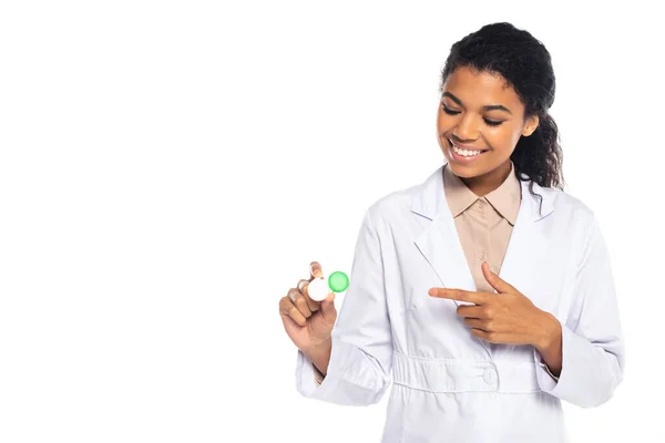 Positive african american doctor pointing with finger at contact lenses isolated on white — Stock Photo