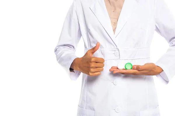 Cropped view of african american doctor holding contact lenses and doing like sign isolated on white — Stock Photo