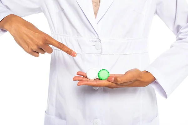 Cropped view of african american ophthalmologist pointing at contact lenses in container isolated on white — Stock Photo