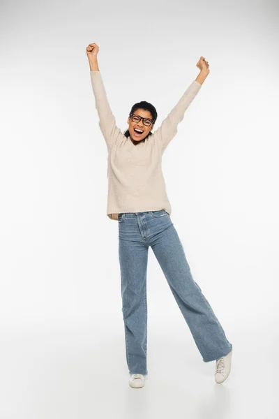 Excited african american woman in eyeglasses on white background — Stock Photo