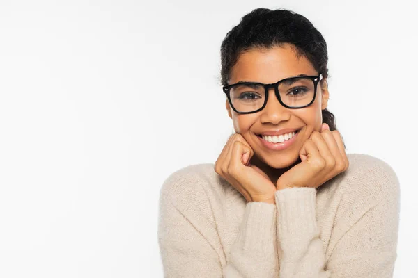 Portrait of smiling african american woman in eyeglasses and sweater isolated on white — Stock Photo