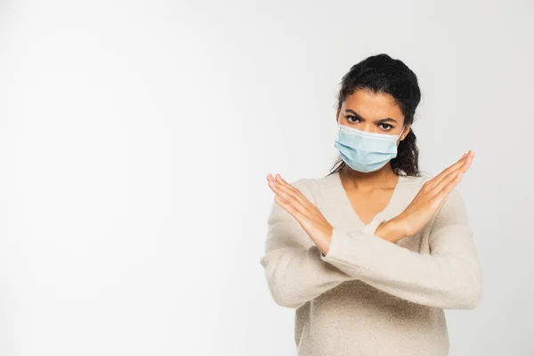 Grave donna afroamericana in maschera medica che non mostra alcun gesto isolato su bianco — Foto stock