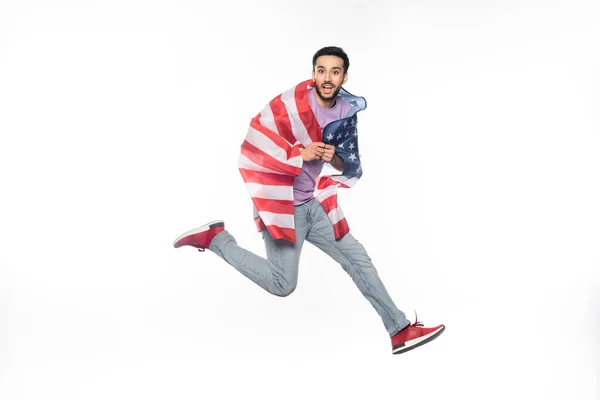 Hombre feliz y patriótico saltando con bandera americana aislada en blanco - foto de stock