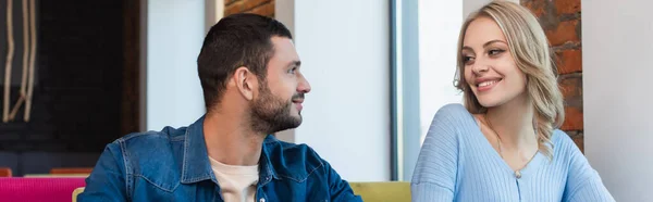 Happy young couple looking at each other while spending time in cafe, banner — Stock Photo