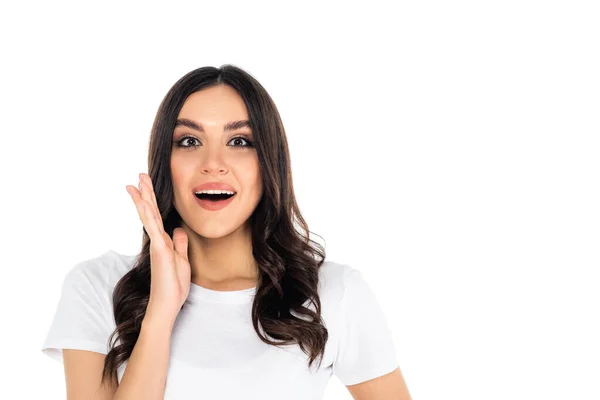 Thrilled woman with open mouth holding hand near face while looking at camera isolated on white — Stock Photo