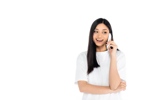 Весела азіатська жінка в футболці, що телефонує на мобільний телефон ізольовано на білому — стокове фото