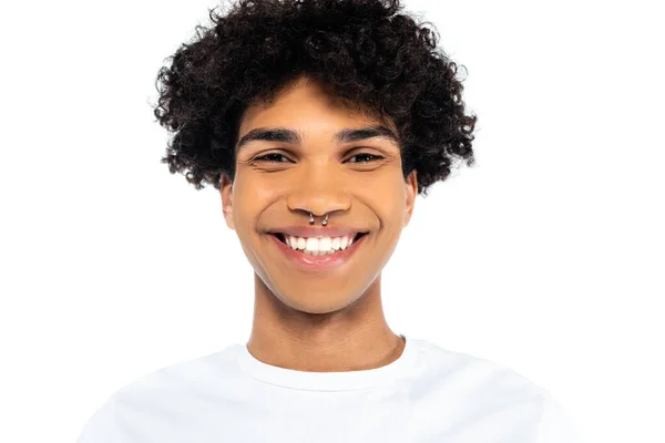 Portrait of curly african american man with piercing smiling at camera isolated on white — стоковое фото