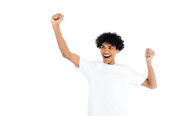 Young excited african american man in t-shirt showing rejoice gesture isolated on white — Stockfoto