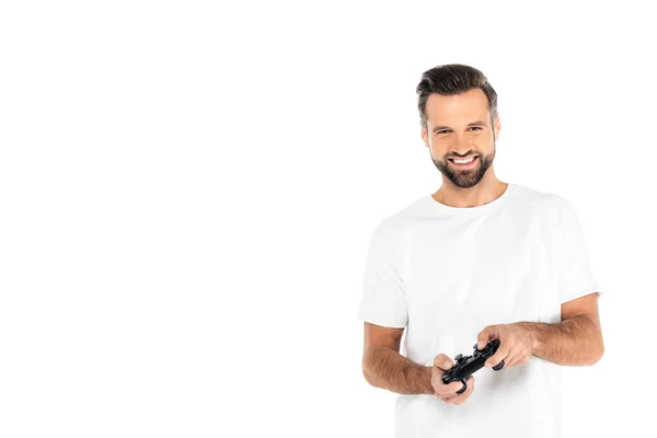 KYIV, UKRAINE - DECEMBER 5, 2021: joyful man in t-shirt gaming with joystick isolated on white — Stock Photo