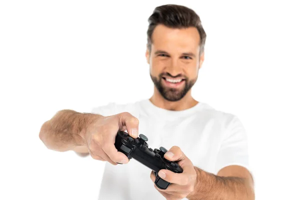 KYIV, UKRAINE - DECEMBER 5, 2021: blurred man smiling while gaming with joystick isolated on white — Stock Photo