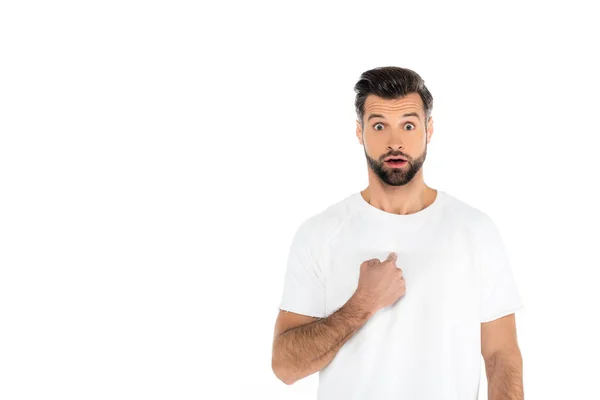 Shocked man with open mouth pointing at himself while looking at camera isolated on white — стоковое фото