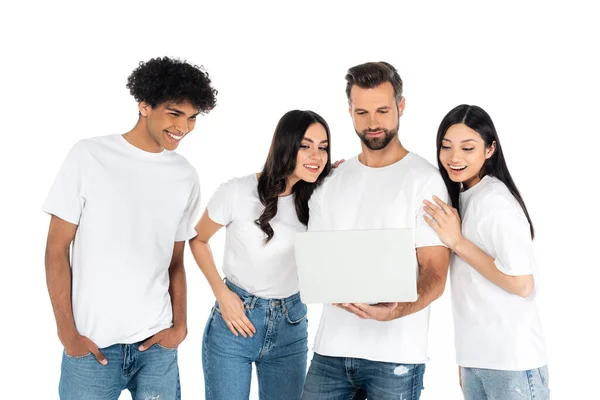 Man using laptop near cheerful interracial friends isolated on white - foto de stock