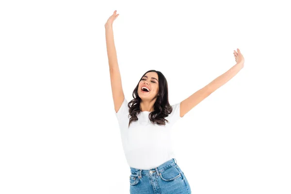Amazed brunette woman standing with closed eyes and raised hands isolated on white — Stock Photo