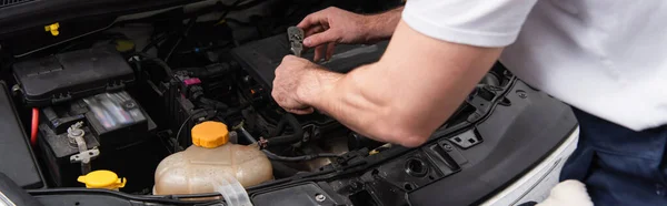 Cropped view of mechanic working with auto in service, banner — Stock Photo