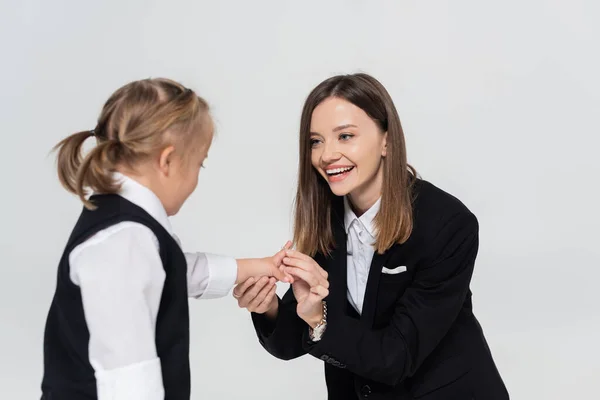 Happy mother holding hands with disabled daughter isolated on grey — Photo de stock