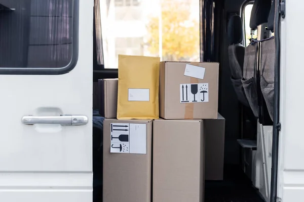 Cardboard boxes with symbols in car — Stockfoto