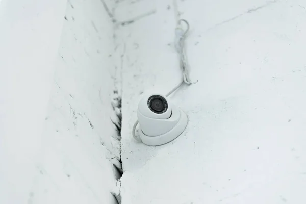 Low angle view of supervision camera on white wall — Stock Photo