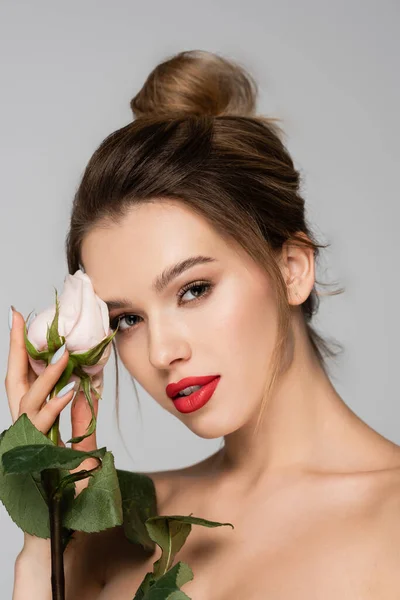 Charming woman holding white rose near perfect face isolated on grey — Stock Photo