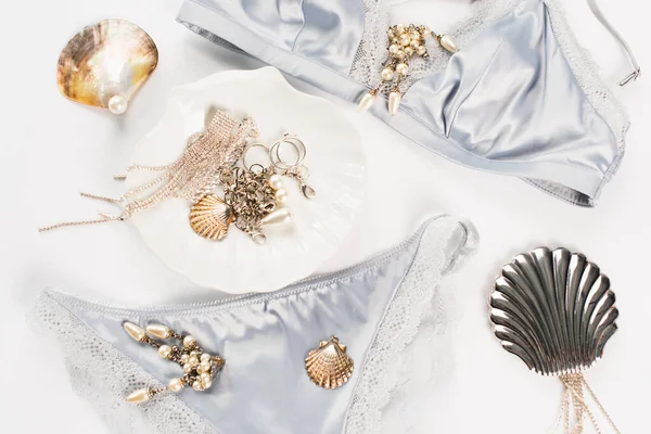 Top view of shells, accessories and underwear on white background — Stock Photo