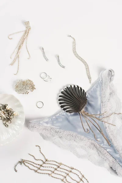 Top view of blue silk panties near accessories on white background — Stock Photo