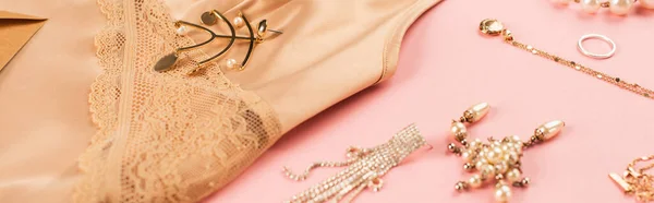 Close up view of accessories near camisole on pink background, banner — Stock Photo