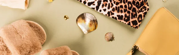 Top view of slippers, bag and bra with leopard print on green background, banner — Stock Photo