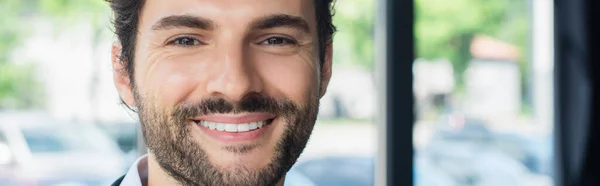 Close up portrait of happy businessman looking at camera in office, banner — Stock Photo