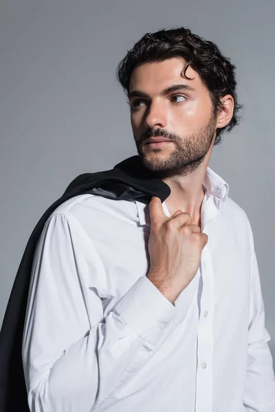 Brunette man in white shirt looking away isolated on grey — Stock Photo