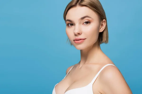 Pretty young woman in white bra isolated on blue — Stock Photo