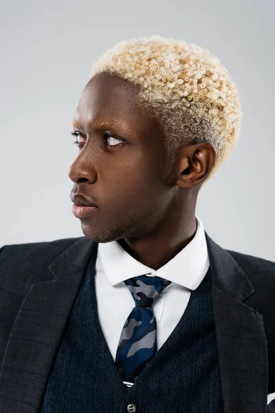 Stylish african american businessman in suit looking away isolated on grey — Stock Photo