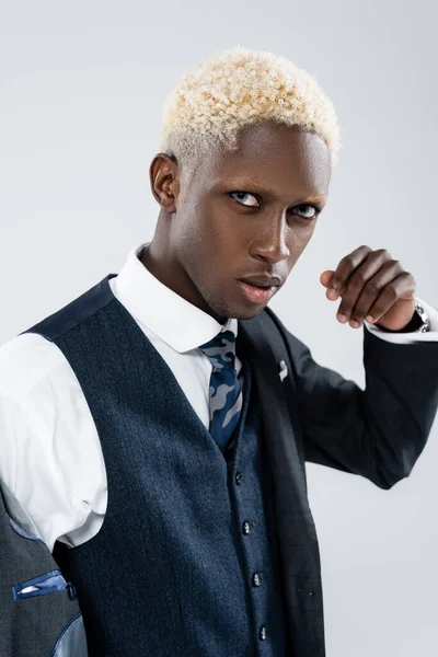 Blonde african american man with blue eyes looking at camera isolated on grey — Stock Photo