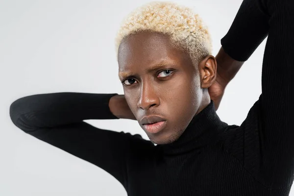 Portrait of young african american man with different eye colors isolated on grey — Stock Photo