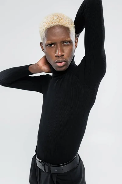 Blonde african american man with different eye colors isolated on grey — Stock Photo