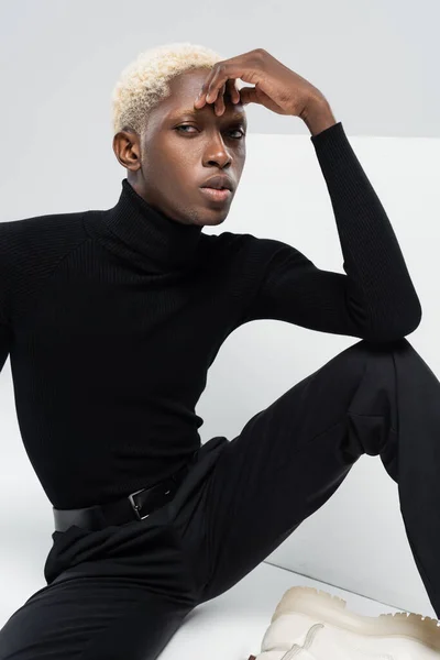 African american man looking at camera on gray — Stock Photo