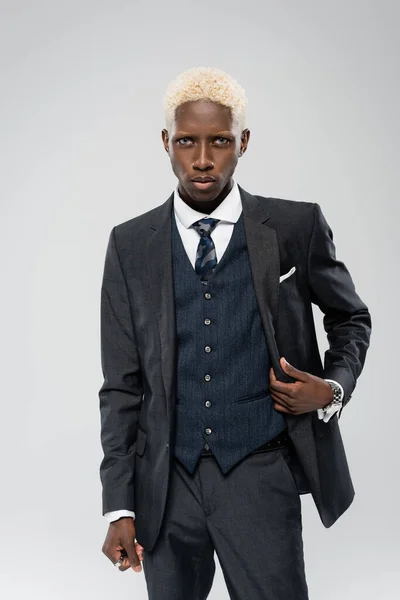 Елегантний афроамериканський чоловік у формальному одязі позує ізольовано на сірому — стокове фото